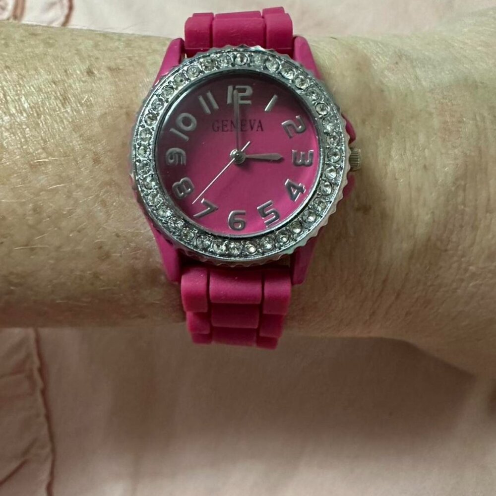 Pink Geneva watch with rhinestone accents.